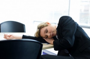 Businesswoman asleep at office table