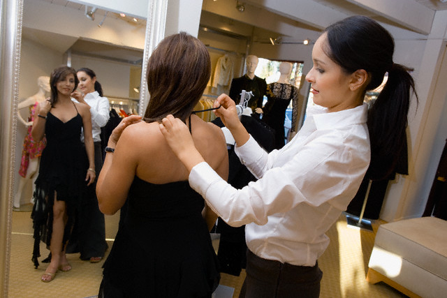 Salesperson Assisting Woman with Cocktail Dress