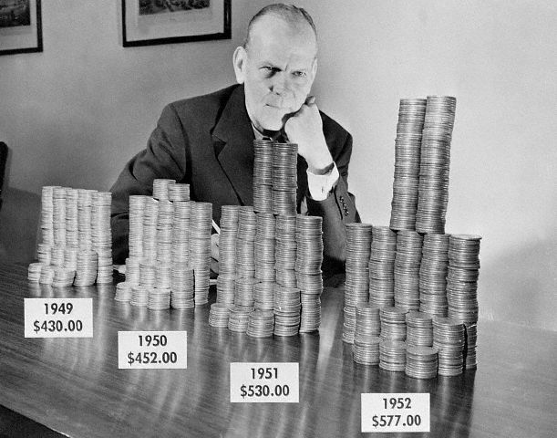 Man Seated W/Coins Representing Tax Incr