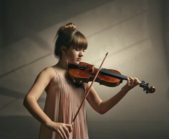 Caucasian girl playing violin